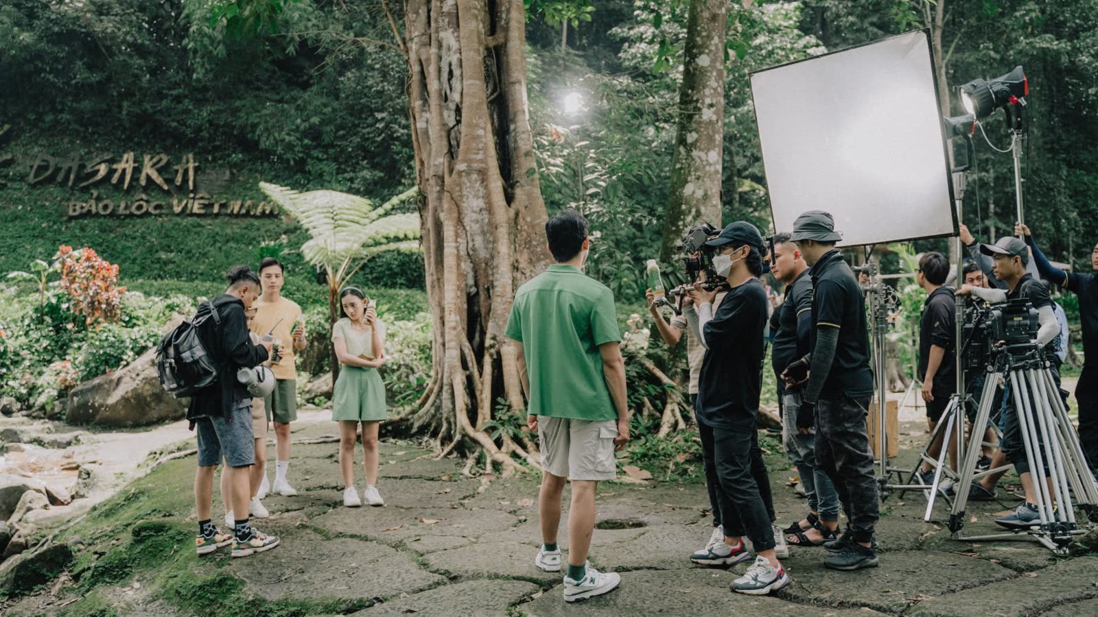 Crew and cast on an outdoor jungle location