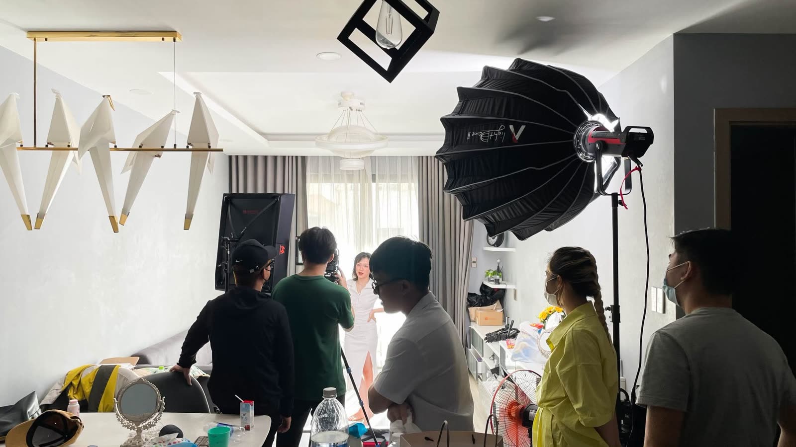 Lighting and crew in a bright interior set