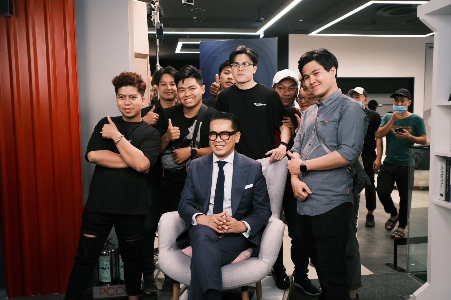 Crew photographed with a guest on a studio set